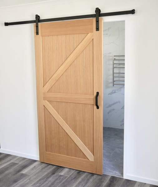 Hardwood American Oak Timber Barn Door. Barn door hanging on black rails. Internal and externa barn doors. Shop online or visit instore