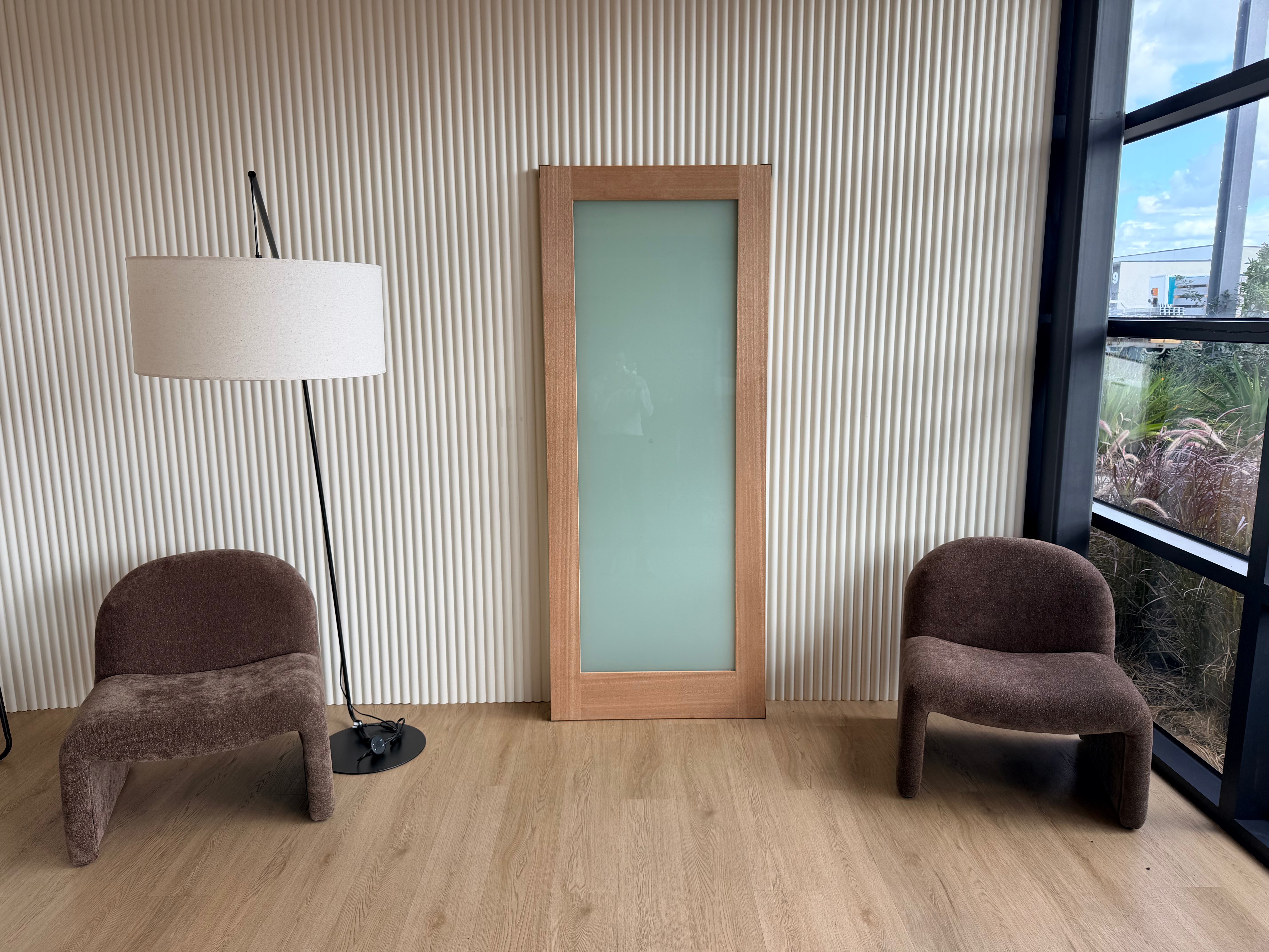 Glass front door resting on a wall