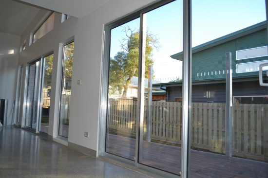 residential sliding stacker door installation leading to a patio area.