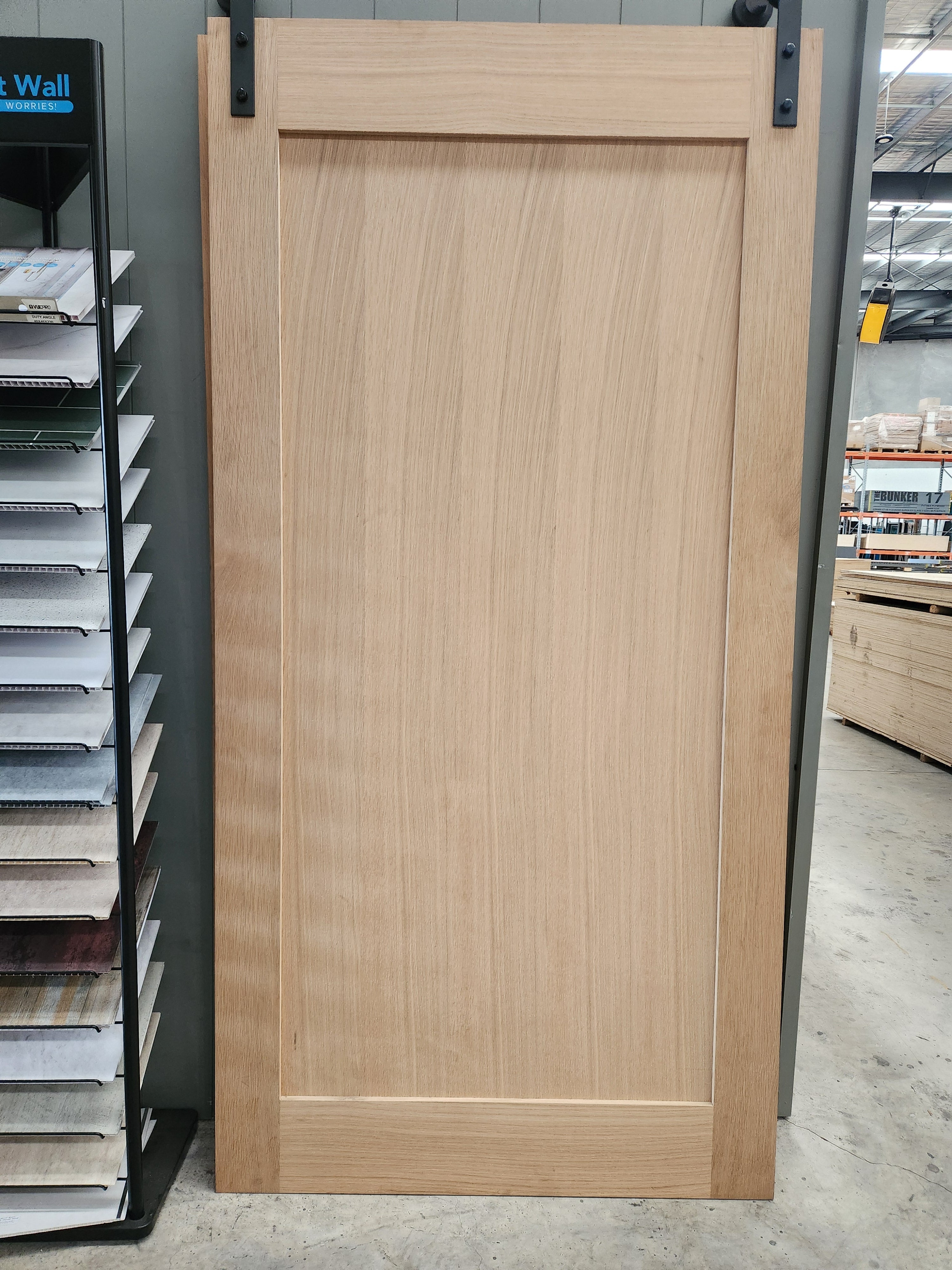 Internal plain barn door with black sliding hardware track